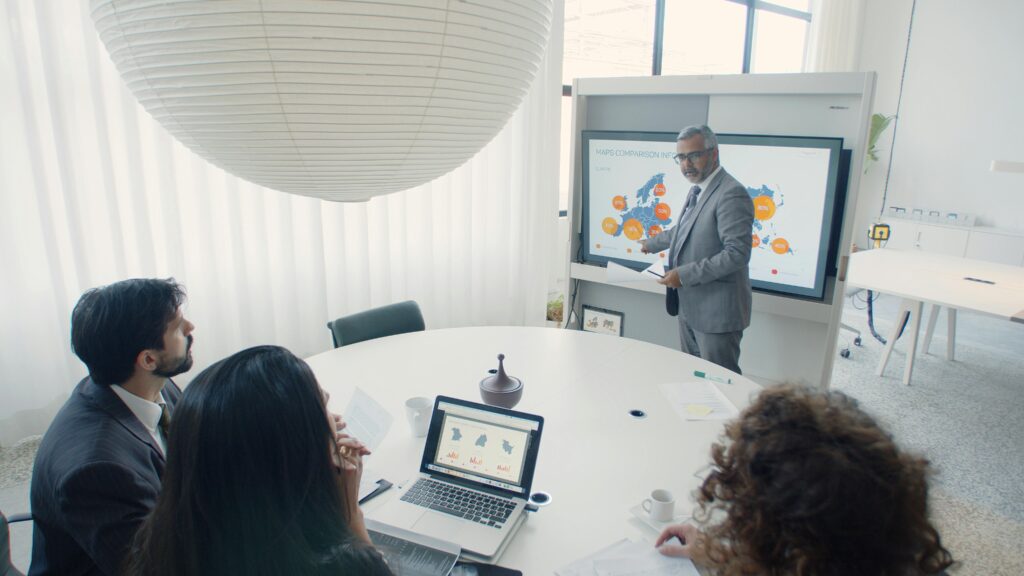Sales leader presents a data map to the team in a meeting.